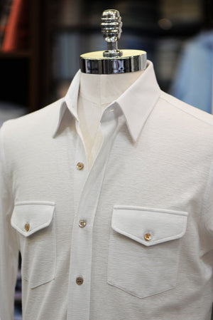 Anto off-white jersey knit shirt with two pockets, showcased on a mannequin.