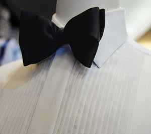Satin finished pleated white Anto tuxedo shirt.